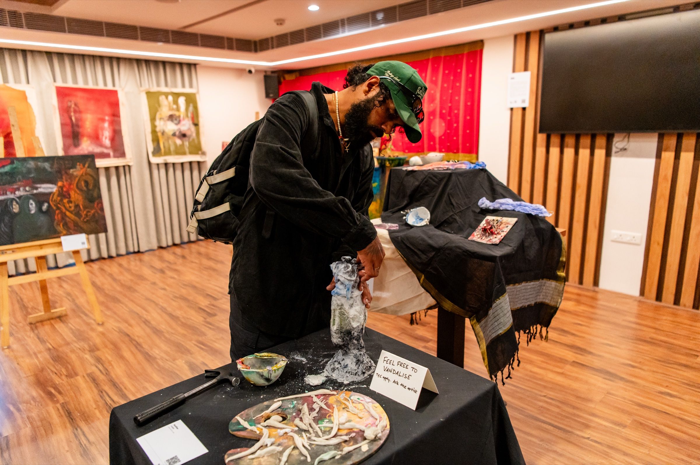 A visitor uses their hands to alter the participatory sculpture in The Gallery.